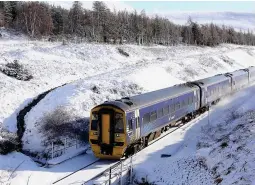  ?? ?? On track: Train on a snowy line near Inverness yesterday