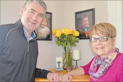  ?? LAWRENCE POWELL/SALTWIRE NETWORK ?? Nova Scotia Premier Stephen McNeil with his wife, Andre are in front of family photos and a vase of 10 yellow roses. Andrea McNeil presented him with the flowers when he arrived home from work on Friday — exactly 10 years to the day he was elected...