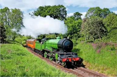  ?? PETER BACKHOUSE ?? Hauling the Scottish Railway Preservati­on Society’s teak stock, LNER ‘D49’ 4-4-0 No. 246 Morayshire climbs through the woods towards the Bo’ness & Kinneil Railway’s Birkhill station on June 3 2012.