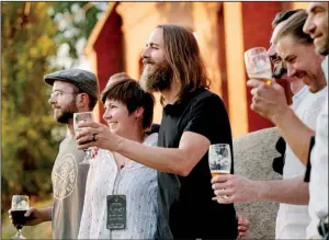  ?? AP ?? Stone Brewing Co. Chief Executive Officer and co-founder Greg Koch (center) toasts a crowd Saturday after announcing the Escondido, Calif., brewery’s plan to make beer in Berlin in this photo provided by Stone Brewing.