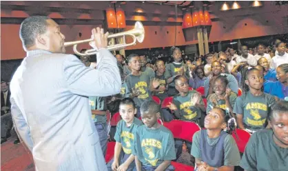  ?? CHERYL GERBER/AP ?? Jazz trumpeter Wynton Marsalis performs for schoolchil­dren in New Orleans in 2006. A little-known 1922 law technicall­y banning jazz in city classrooms was “never really applied” and reversed last week.