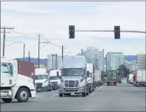  ?? JEFF CHIU – THE ASSOCIATED PRESS ?? Downtown Oakland buildings are shown behind trucks lined up at the Port of Oakland on Feb. 18.