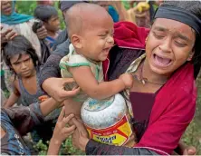  ?? AFP ?? Malaysia’s PM Najib Razak speaks during the deployment of aid for refugees to Chittagong, at the Subang Air Force base in Subang, and (right), a Rohingya woman breaks down after a fight erupted during food distributi­on by volunteers at Kutupalong,...