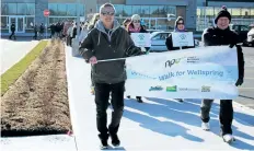  ?? ALLAN BENNER/TRIBUNE STAFF ?? Terry Purser and Joe Matthews lead about a hundred people on a walk through the streets of Fonthill Saturday during Wellspring Niagara's inaugural Winter Walk for Wellspring.