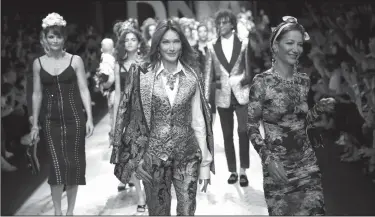  ?? Antonio Calanni/AP ?? Models: Model Carla Bruni Sarkozy, centre, walks with other models as they wear creations as part of the Dolce &amp; Gabbana women's 2019 Spring-Summer collection, unveiled during the Fashion Week in Milan, Italy, Sunday.