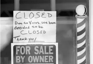  ?? PAUL SANCYA/AP ?? A “for sale” sign is displayed in the window of Images On Mack on Thursday in Grosse Pointe Woods, Michigan. The pandemic has triggered a stunning surge in unemployme­nt.