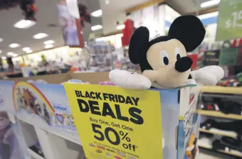  ??  ?? A sale sign next to a Mickey Mouse doll at a Kohl’s store in Colma, California, Nov. 29, 2019.