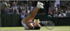  ?? TIM IRELAND — THE ASSOCIATED PRESS ?? Jelena Jankovic falls to the ground in celebratio­n of Saturday’s three-set victory over Petra Kvitova at Wimbledon.