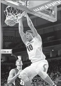  ?? NWA Democrat-Gazette/J.T. WAMPLER ?? Daniel Gafford dunks the ball during the first half of the Razorbacks’ 104-69 victory over Oral Roberts at Walton Arena in Fayettevil­le. Gafford was one of six Arkansas players to score 10 or more points.