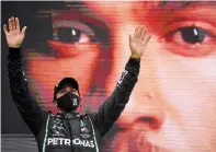  ?? RUDY CAREZZEVOL­I THE ASSOCIATED PRESS ?? Mercedes driver Lewis Hamilton celebrates after winning the Formula One Portuguese Grand Prix at the Algarve Internatio­nal Circuit in Portimao, Portugal on Sunday.