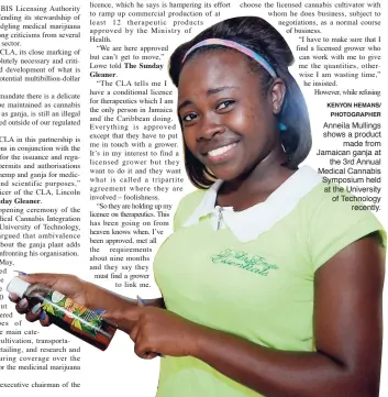  ?? KENYON HEMANS/ PHOTOGRAPH­ER ?? Anneila Mullings shows a product made from Jamaican ganja at the 3rd Annual Medical Cannabis Symposium held at the University of Technology recently.