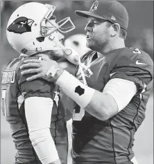  ?? EPA ?? MISSTER CATANZARO: Carson Palmer (right) consoles Chandler Catanzaro after his missed field goal in overtime proved costly to the Cards and Hondo.