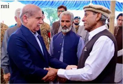  ?? ?? Talagang: PM Shehbaz Sharif offers condolence­s to the family of Captain Ahmed Badar Shaheed at their residence in Talagang.