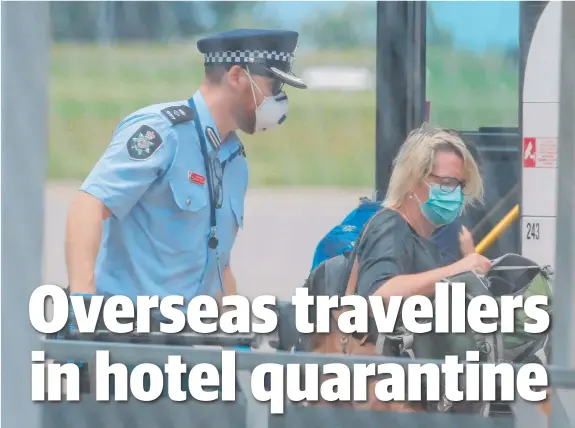  ?? Picture: GLENN CAMPBELL ?? Passengers from overseas flights at Darwin airport are taken by bus to a hotel where they face a 14-day quarantine