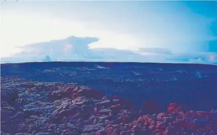  ?? Photos by the U.S. Geological Survey, via The Associated Press ?? The ash plume from the Kilauea volcano — as seen from a webcam on Mauna Loa, about 20 miles away — rose about 30,000 feet Thursday.