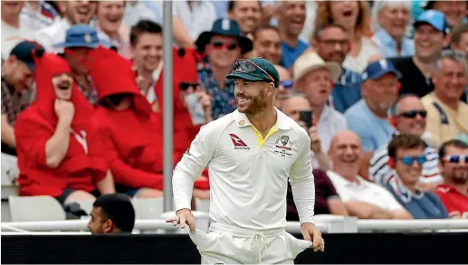  ?? GETTY IMAGES ?? Controvers­ial Australian batsman David Warner shows his sandpaper-free pockets to the Edgbaston crowd.