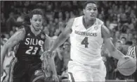  ?? NWA Media/ben GOFF ?? Arkansas’ Coty Clarke drives to the basket as Southern Illinois-Edwardsvil­le’s Rozell Nunn defends Friday night.