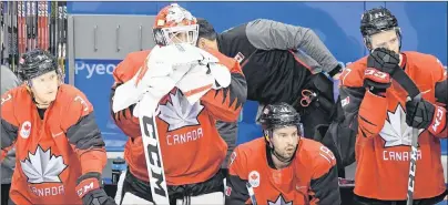  ?? THE CANADIAN PRESS/NATHAN DENETTE ?? Canada goaltender Kevin Poulin and teammates look on as Germany celebrates their win in semifinal Olympic men’s hockey action at the 2018 Olympic Winter Games in Gangneung, South Korea, on Friday.