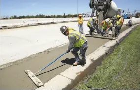  ?? Rich Pedroncell­i / Associated Press ?? Workers repave a street in Roseville, partially funded by a gas tax increase passed by the Legislatur­e in 2017. Republican­s are supporting a tax repeal.