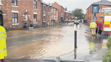  ??  ?? Firefighte­rs pumped floodwater from Croston village