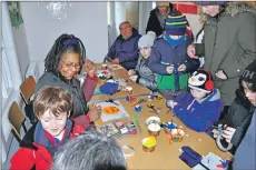  ??  ?? Visitors enjoy a fun activity creating crafty crawlies out of household items.