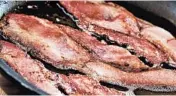  ?? ELENA ELISSEEVA/DREAMSTIME ?? Fry up thick-sliced bacon until crispy, then crumble the strips after they cool and refrigerat­e for use the next day.