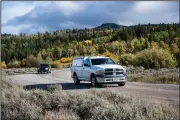  ?? (AP/Jackson Hole News & Guide/Meg Potter) ?? A Teton County coroner vehicle (front) transports a body believed to be that of Gabby Petito on Sunday from a camping area at Grand Teton National Park in Wyoming.