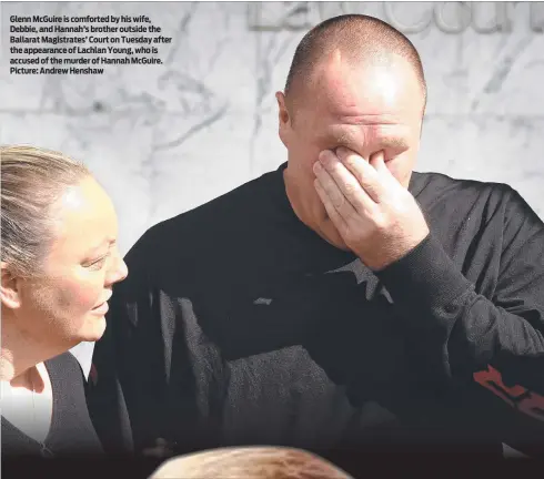  ?? ?? Glenn McGuire is comforted by his wife, Debbie, and Hannah’s brother outside the Ballarat Magistrate­s’ Court on Tuesday after the appearance of Lachlan Young, who is accused of the murder of Hannah McGuire. Picture: Andrew Henshaw