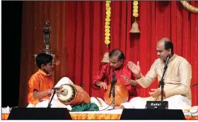  ?? Arkansas Democrat-Gazette/FRANCISCA JONES ?? Siddharth Sridharan (left) plays the mridangam in the Indian performanc­e debut known as an arangetram, accompanyi­ng ghatam player Adambakkam Shankar, vocalist Delhi Sunderraja­n, and violinist Vignesh Thyagaraja­n (not pictured) on Sept. 7.