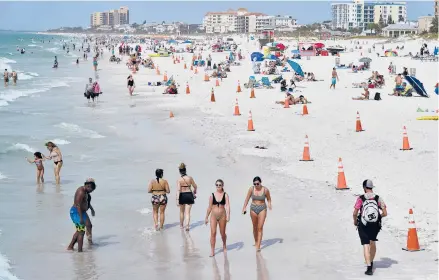 ?? CHRIS O’MEARA/AP ?? Beachgoers enjoy their time last week in Clearwater, Florida, a popular spring break destinatio­n, west of Tampa. Colleges around the country are scaling back or canceling spring break to discourage partying amid the pandemic.