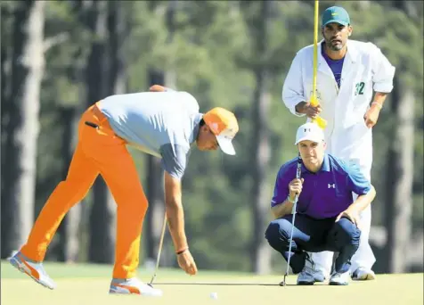  ?? Andrew Redington/Getty Images ?? Rickie Fowler, left, marks his ball as Jordan Spieth lines up a putt on the eighth hole of the final round at Augusta National a week ago. Neither made the charge many expected of them.