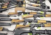  ?? MATT YORK / ASSOCIATED PRESS 2011 ?? A cache of seized weapons is displayed at a Bureau of Alcohol, Tobacco, Firearms and Explosives news conference in Phoenix.