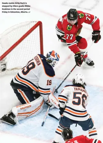  ?? AP ?? Hawks rookie Kirby Dach is stopped by Oilers goalie Mikko Koskinen in the second period Friday in Edmonton, Alberta.