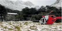  ??  ?? The Nelson Marlboroug­h Rescue Helicopter lands at Upper Travers Hut after the first snowfall of the year.