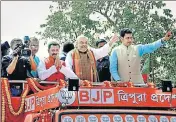  ?? PTI PHOTO ?? BJP president Amit Shah waves at supporters during a roadshow in Agartala, Tripura, on Sunday.