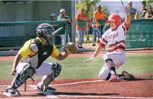  ??  ?? Robertson’s Antonio Padilla slides into home during the fifth inning against West Las Vegas.