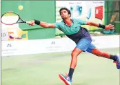  ??  ?? Manish Sureshkuma­r stretches to play a forehand shot during his match against Madhwin on Thursday.