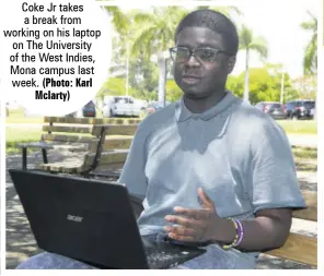  ?? (Photo: Karl Mclarty) ?? Michael
Coke Jr takes a break from working on his laptop on The University of the West Indies, Mona campus last week.