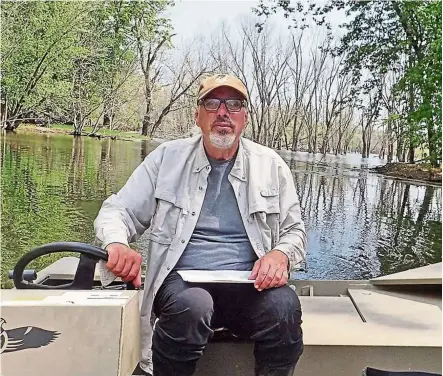  ??  ?? stravers listens for cerulean warblers on a backwater of the Mississipp­i river near his home in McGregor, Iowa, the united states. he is a free-sprited, independen­t wildlife researcher. — TOny Kennedy/Tns