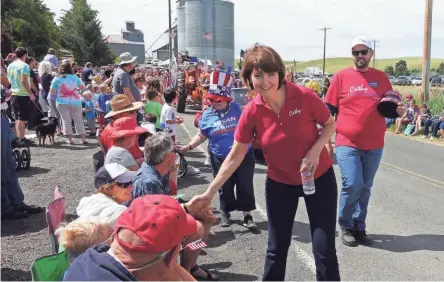  ??  ?? Rep. Cathy McMorris Rodgers, R-Wash., shakes hands during the Fourth of July Parade in Johnson, Wash.