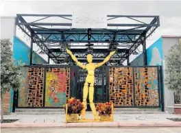  ?? MIKE STOCKER/SOUTH FLORIDA SUN SENTINEL ?? A yellow metalwork figure with arms outstretch­ed greets visitors on the sidewalk outside Shipyard, a Wynwood Yard-style entertainm­ent village opening Saturday. Shipyard will bring what its owners believe is a much-needed source of nightlife, live music, art and food to Tyler Street in downtown Hollywood.