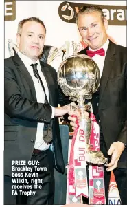  ??  ?? PRIZE GUY: Brackley Town boss Kevin Wilkin, right, receives the FA Trophy