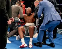  ?? PA via AP ?? Dereck Chisora is helped up after being knocked out by Dillian Whyte.