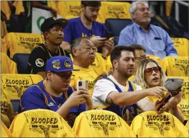  ?? SHAE HAMMOND — STAFF PHOTOGRAPH­ER ?? Fans watch player warmups at the Chase Center before Game 5 of the NBA Finals between the Warriors and the Boston Celtics on Monday night.