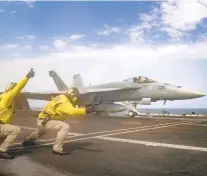  ?? JEFF SHERMAN/ASSOCIATED PRESS ?? An F-18 Super Hornet is launched from the deck of the USS Abraham Lincoln in the Arabian Sea.