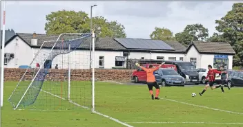  ?? 01_B38footy04 ?? Archie McNicol powers towards goal to score for Arran.