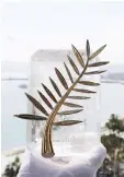  ??  ?? A Chopard representa­tive displays the Palme d’Or, the highest prize awarded to competing films, during an interview before the start of the Festival. • (Left) Voice cast members Anke Engelke, Janina Uhse, and Lesia Nikitiuk pose on a pier during a...