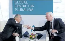  ?? FRED CHARTRAND/THE CANADIAN PRESS ?? Gov. Gen. David Johnston, right, and the Aga Khan shake hands at the opening for the new home of the Global Centre for Pluralism in Ottawa.