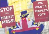  ?? REUTERS ?? An anti-Brexit protestor holds up placards near the Parliament in London on Wednesday.