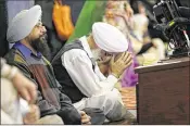  ?? TED S. WARREN / ASSOCIATED PRESS ?? A man bows his head as he attends Sunday services at the Gurudwara Singh Sabha of Washington, a Sikh temple in Renton, Wash.